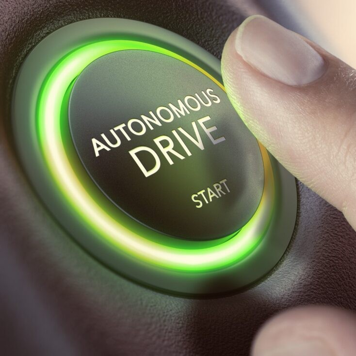 Finger pressing "autonomous drive" button